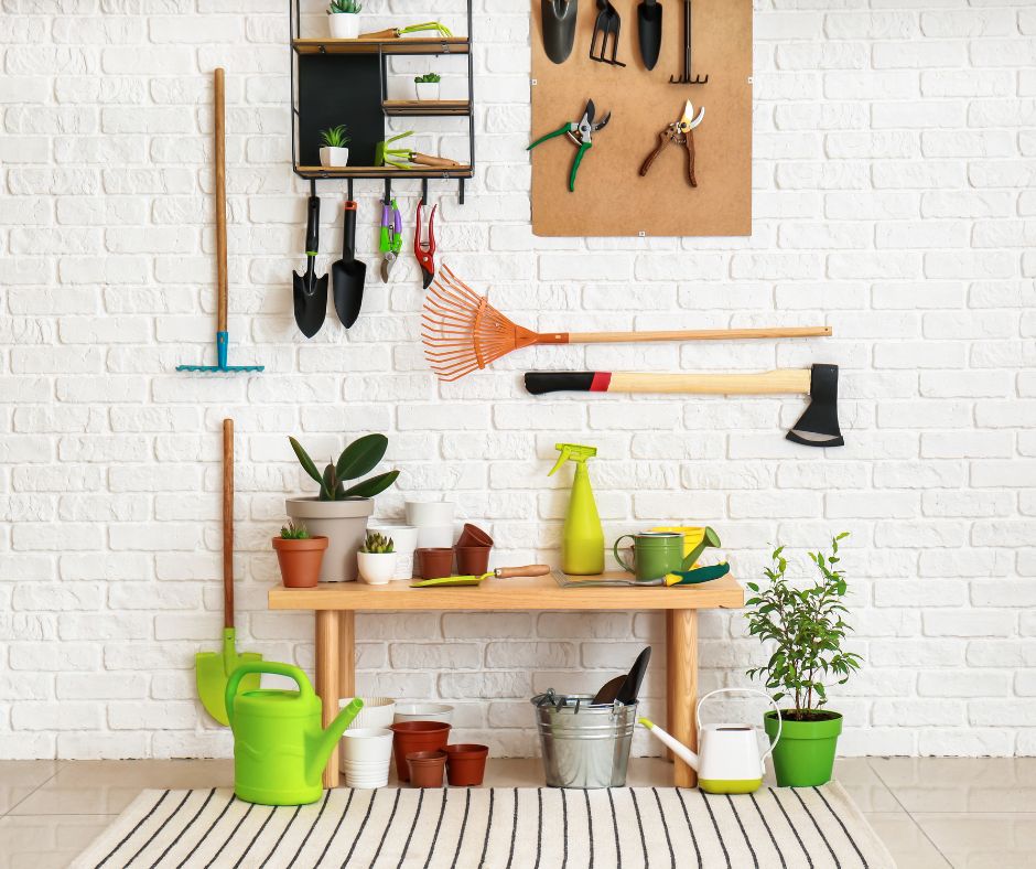 Well organized selection on garden tools. Tools are mounted on a wall and on place on a wooden bench.