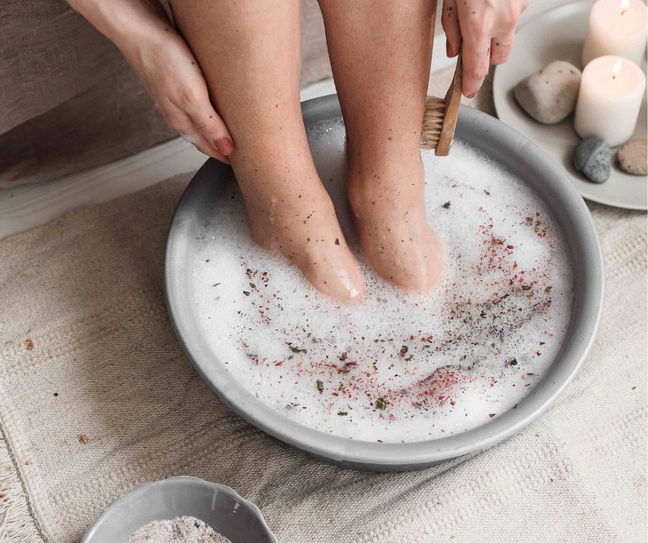 A person enjoying a botanical foot bath.