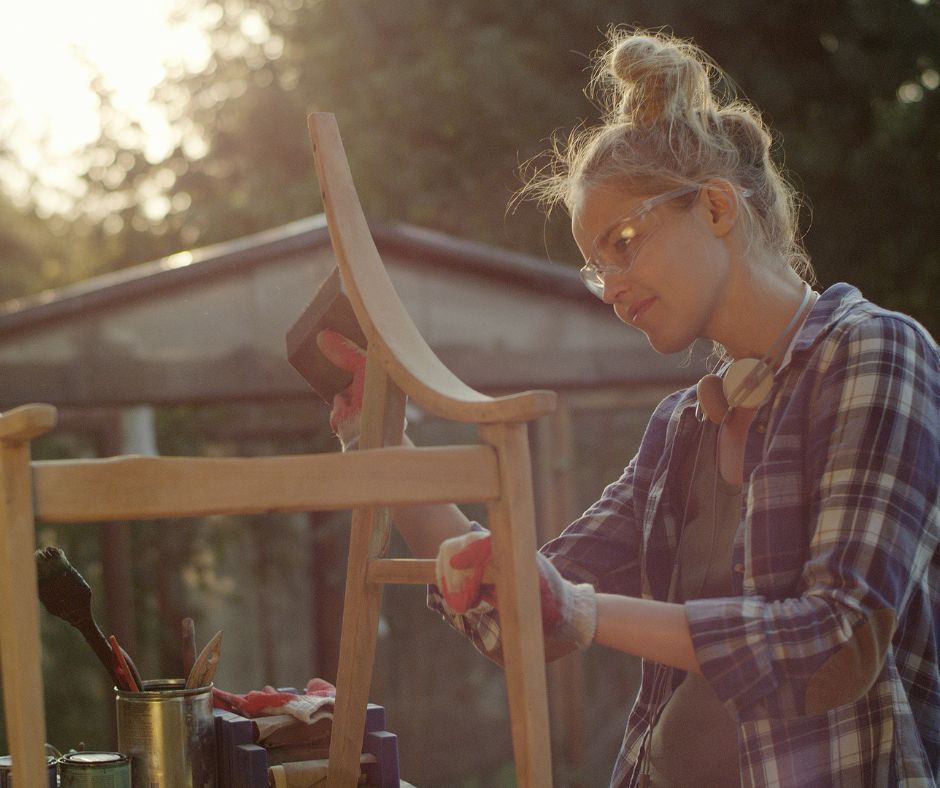Lady working a wooden garden trellis project.