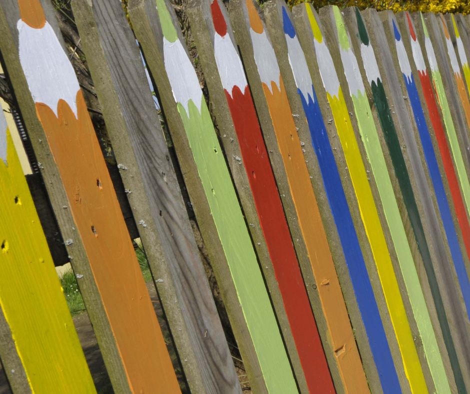 Cute colorful pencils painted on a wooden fence