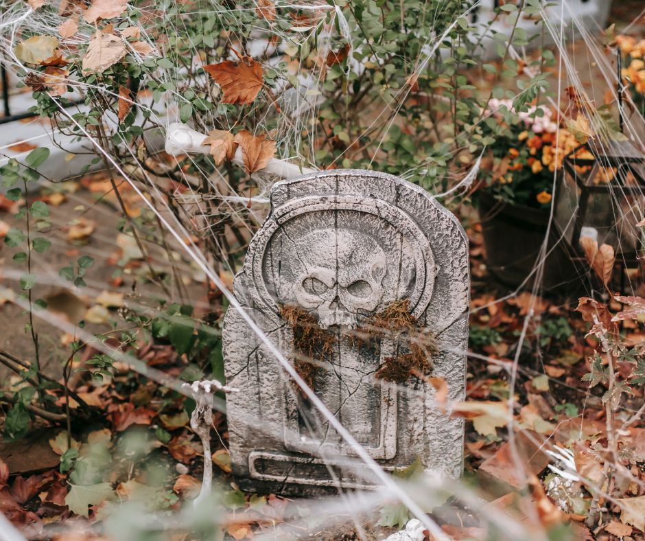 Graveyard Halloween decorations with spider webs and bones.
