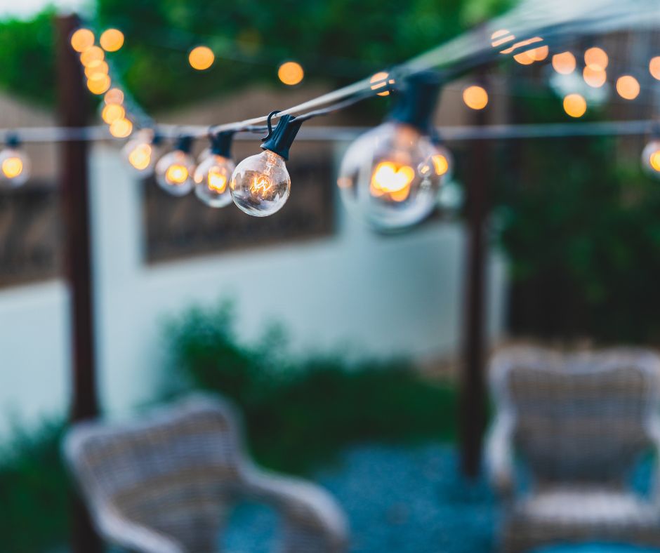 String light above a garden sitting area.