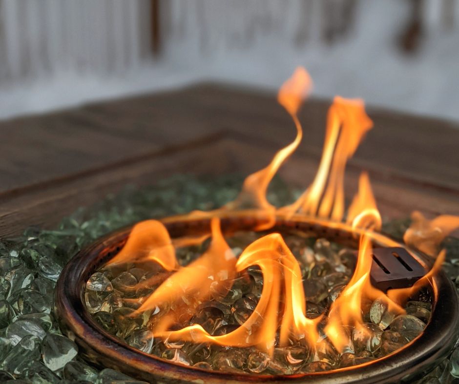 Propane patio firepit with glass rocks.