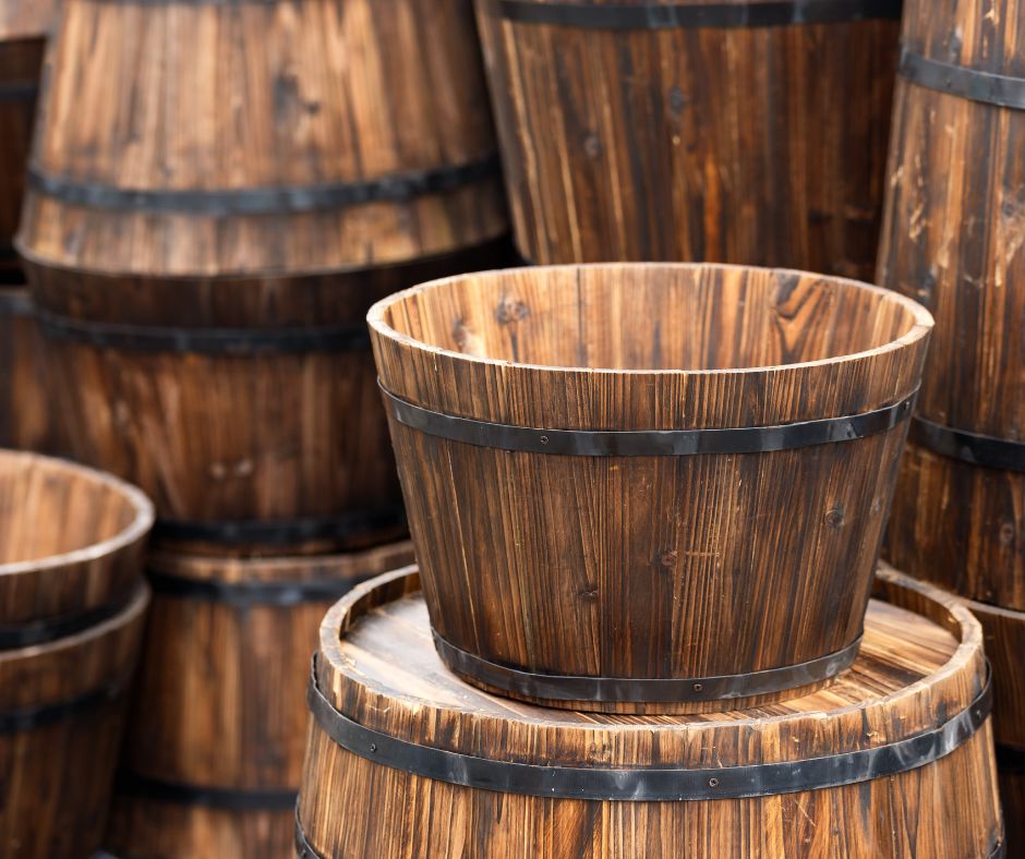 Empty wooden containers with metal banding stacked at a garden center.