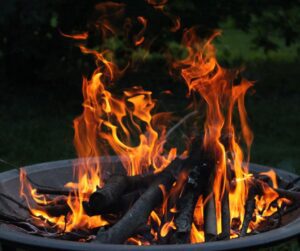 Wood burning in a portable metal bowl fire pit.