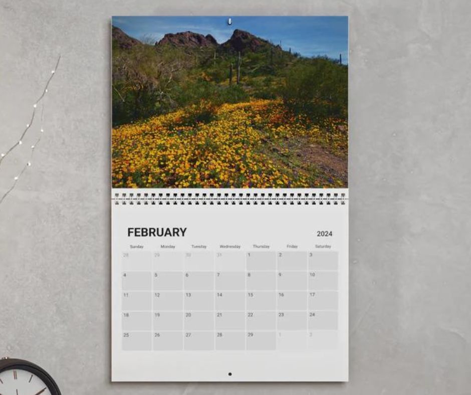 A calendar open to month of February featuring an image of a desert wildflower bloom.