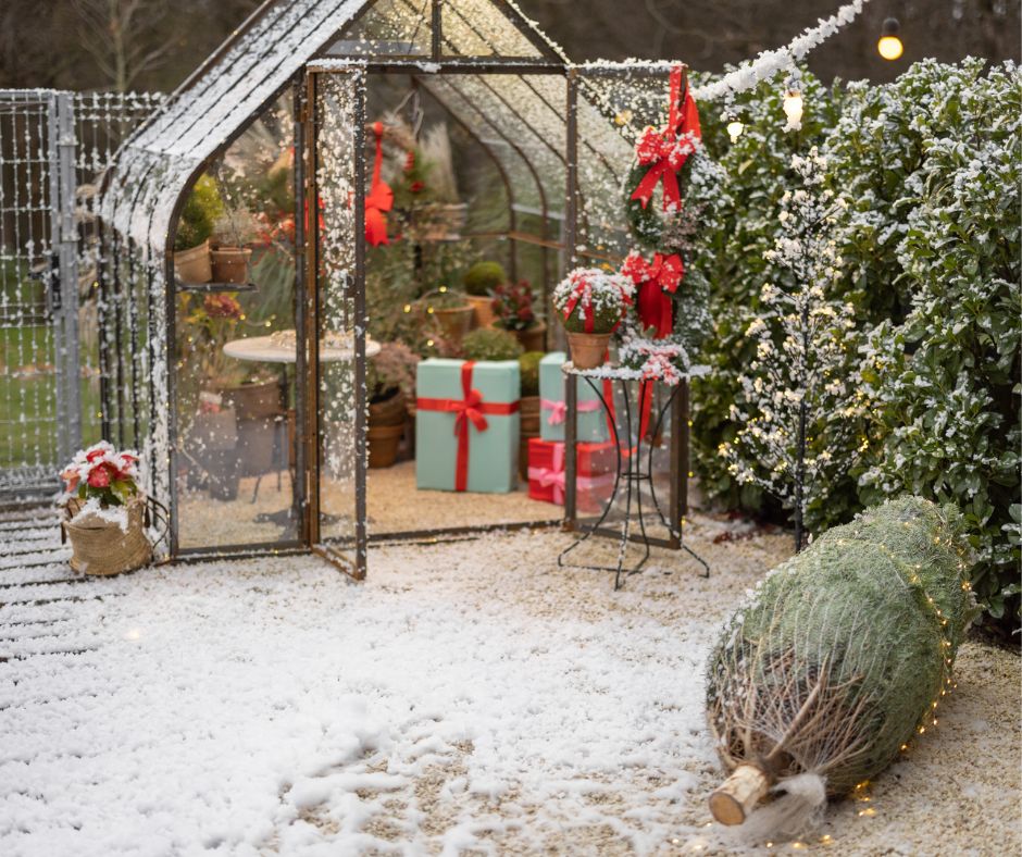A small greenhouse decorated for the holidays.