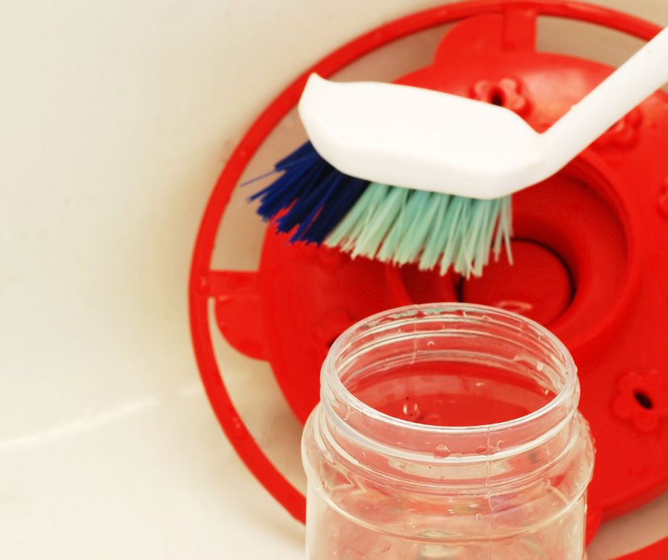 A brush cleaning a hummingbird feeder.