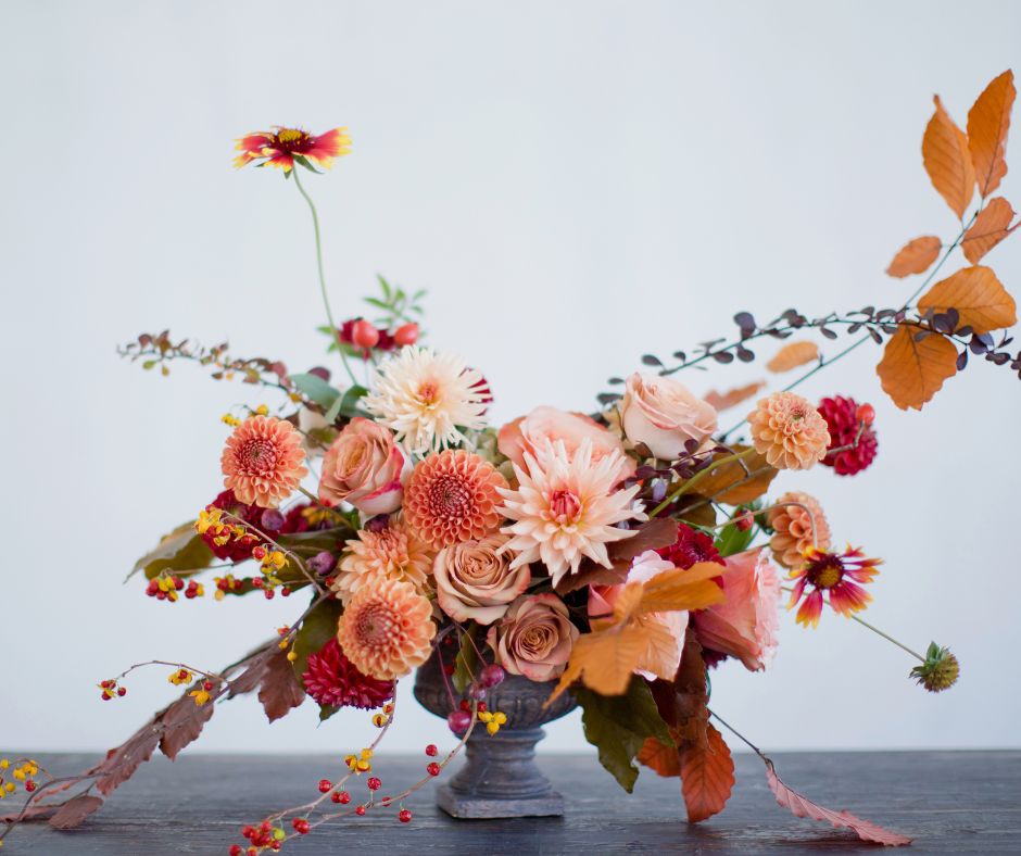 An autumn flower bouquet in shades of apricot and pink in a vase from a backyard cut flower garden.