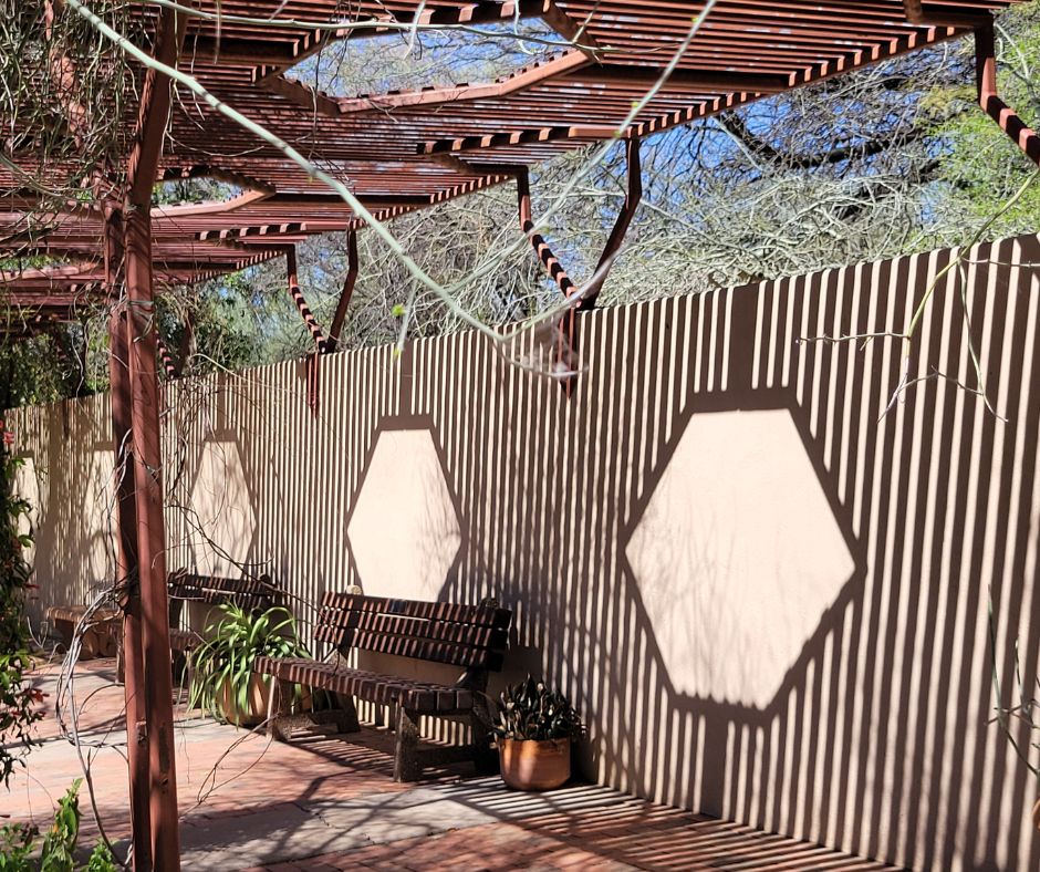 An interesting garden wall with a pattern created by a trellis cast on it.