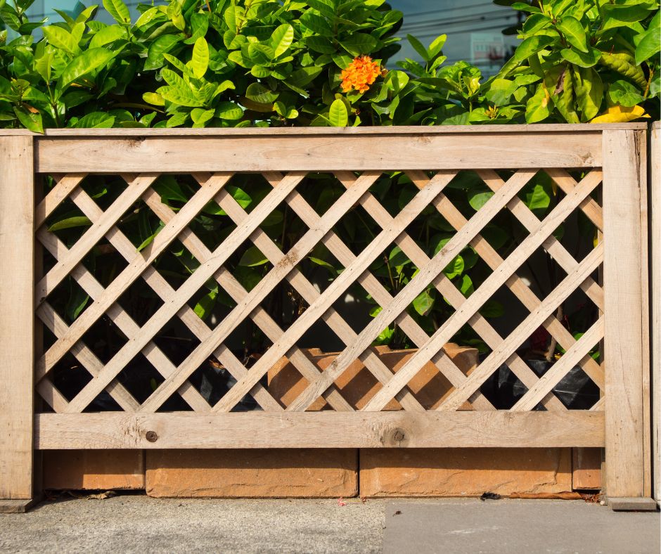 A short fence made of framed lattice sections.
