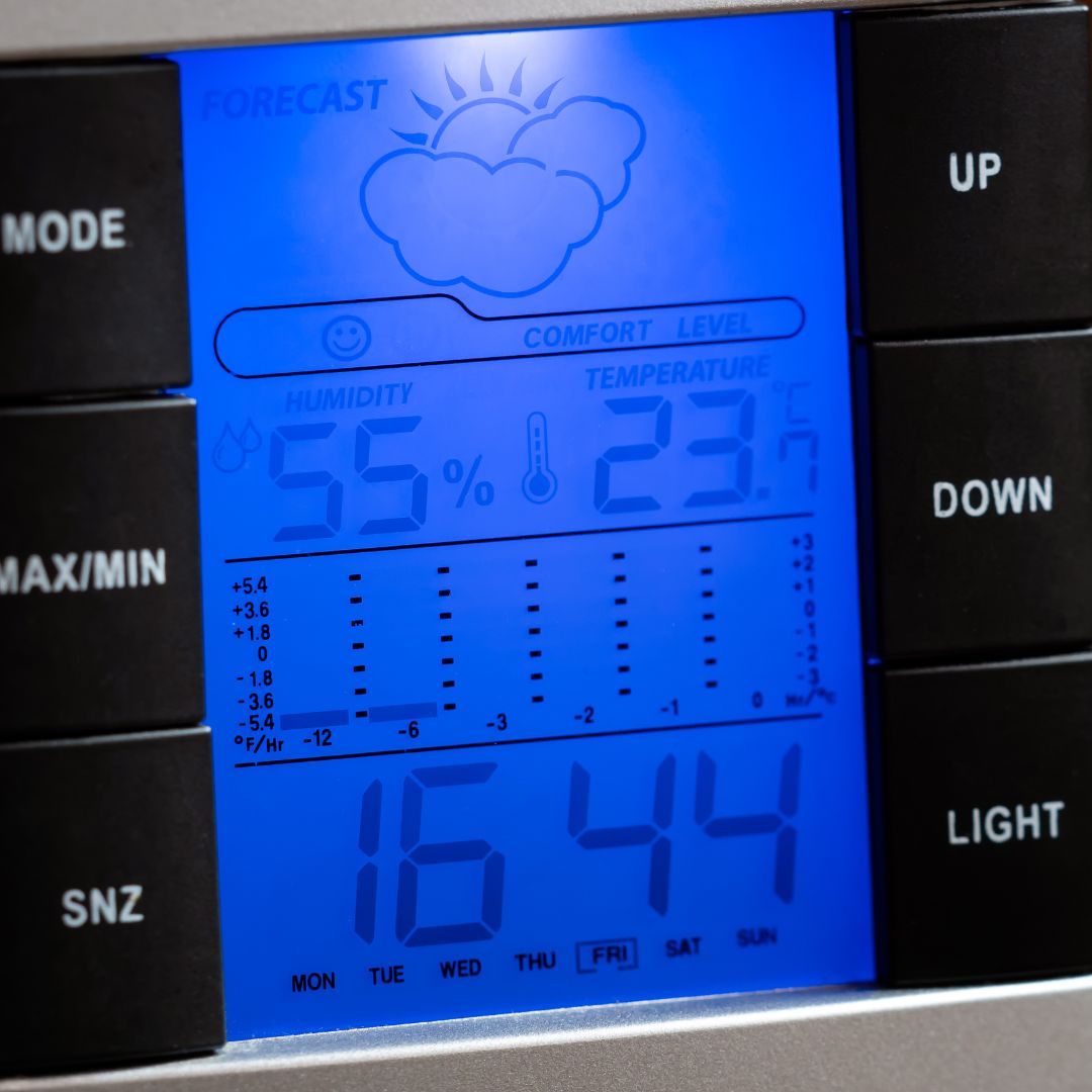 A digital weather station with a blue background.