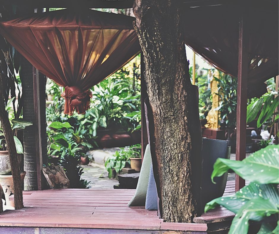 Large mosquito net canopies in a tropical garden.