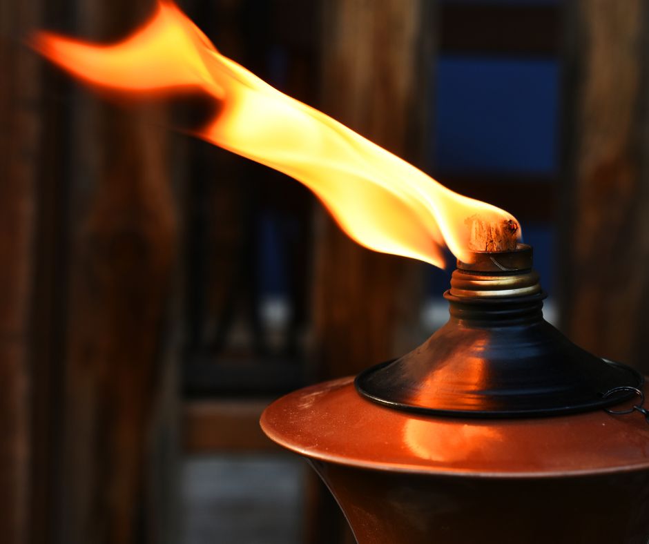A burning metal table torch.