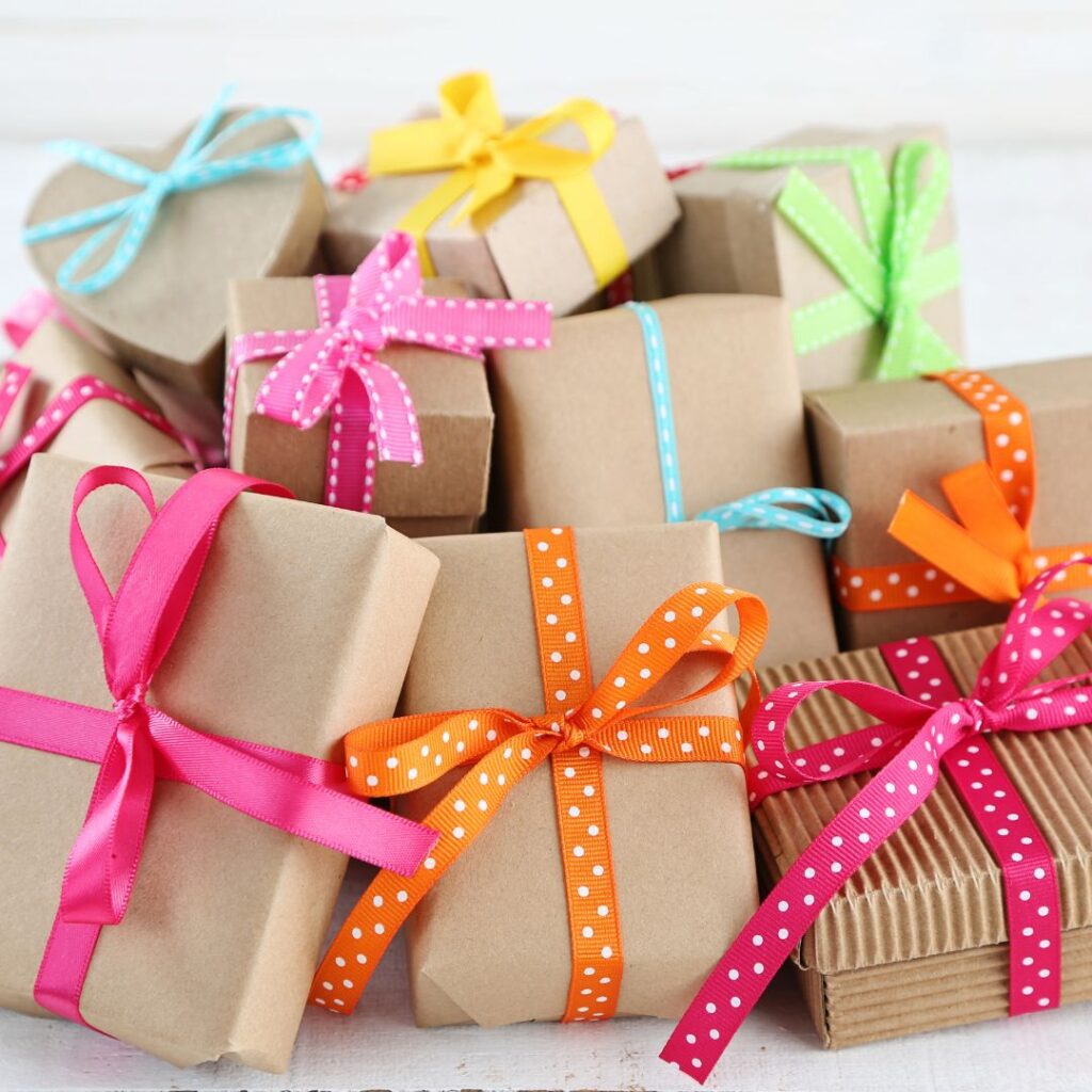 A large assortment of wrapped gifts with bright ribbon.