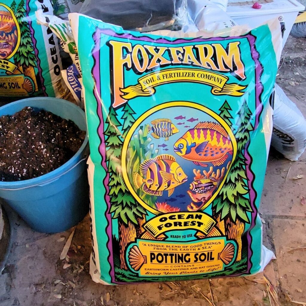 A bag of Foxfarm potting soil next to a bag of soil.