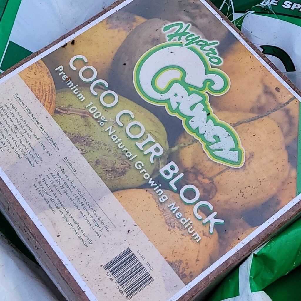 A block of Hydro Crunch coco coir block on a plastic tarp.