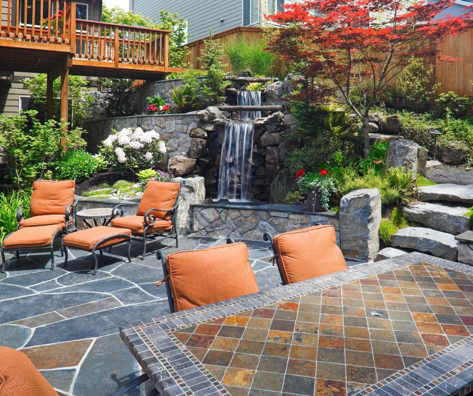 A large waterfall on a backyard patio.