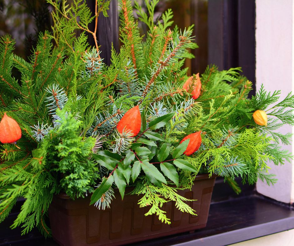 A natural window piece made of a mix of dried leaves, branches and flowers.