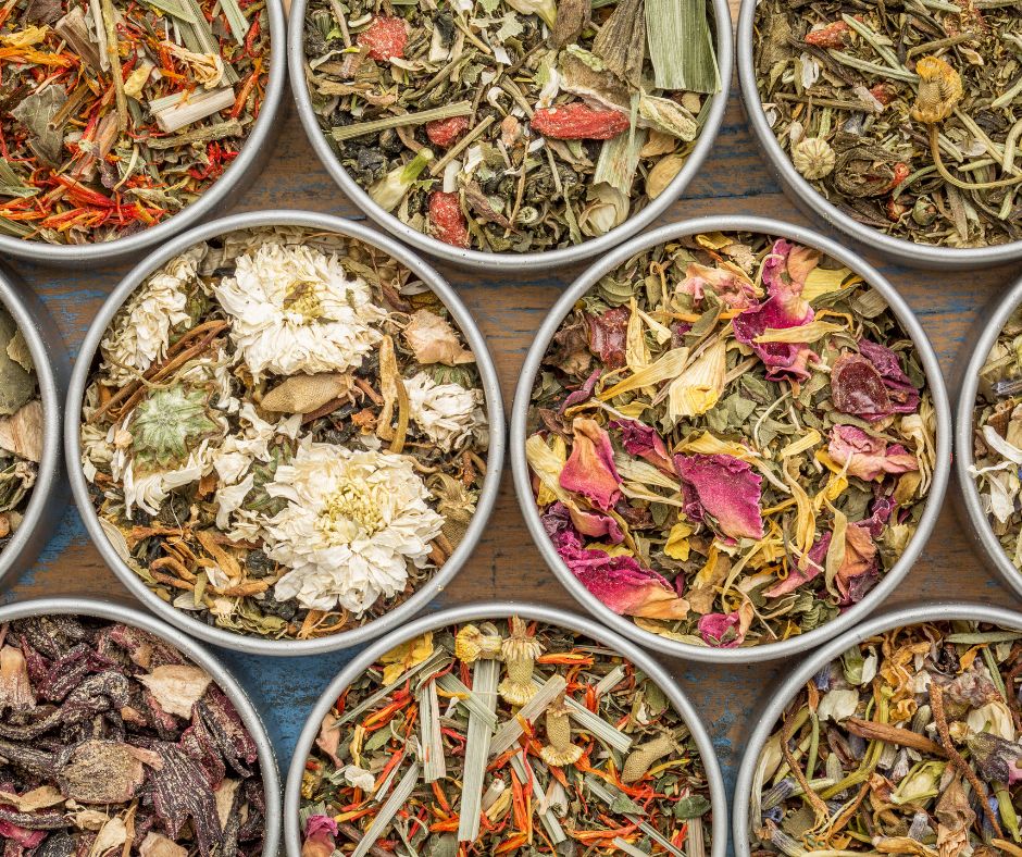 A collection of herbal tea blends in stainless steel tins.