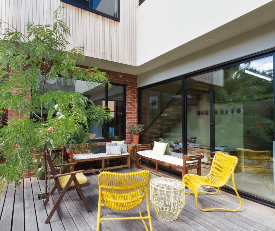 A patio seating area next to large sliding doors.