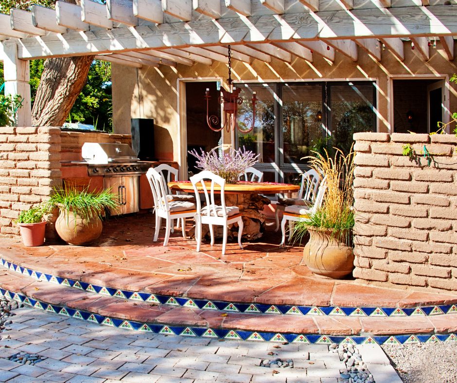 Southwest style hybrid living area including an outdoor kitchen and seating.