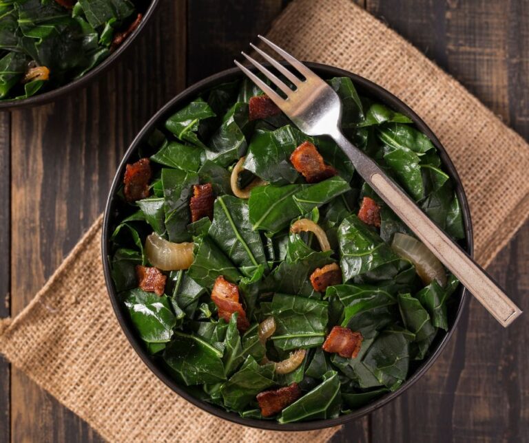 A plate of cooked collard greens and turkey.