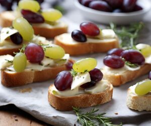 Small rounds of bread toped with red and green grapes, cheese and rosemary.