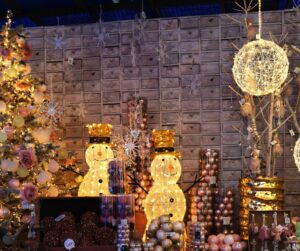 Holiday patio decorations including light snowmen, tree, and hanging light balls.