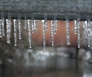 Icicles forming on a ledge during a winter storm.