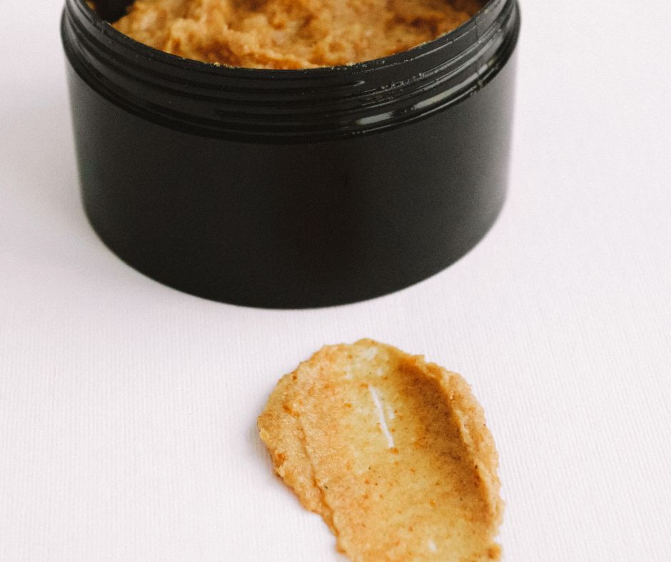 Brown sugar lip scrub in a black container.