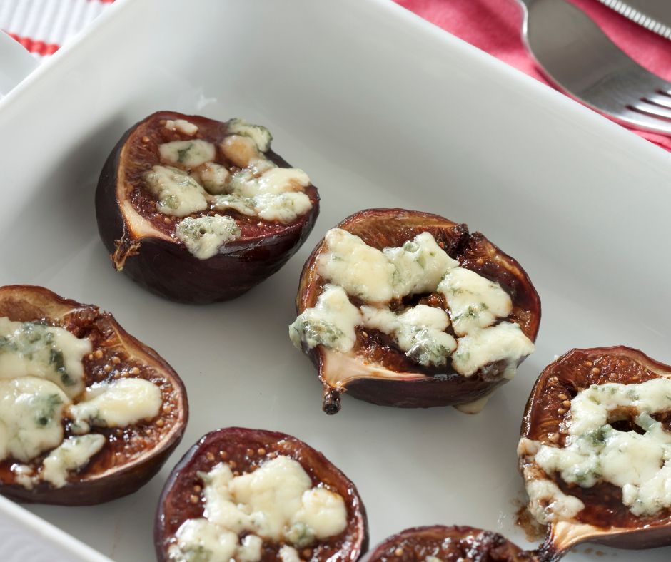 A white dish of roast fig topped with ricotta cheese.