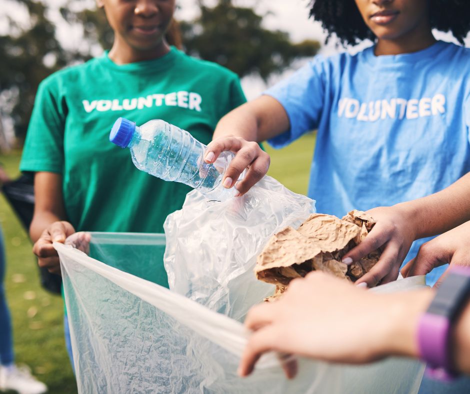 A community volunteers collecting litter that provide habitat for mosquitoes.