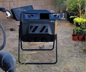 A new compost tumbler in a backyard.