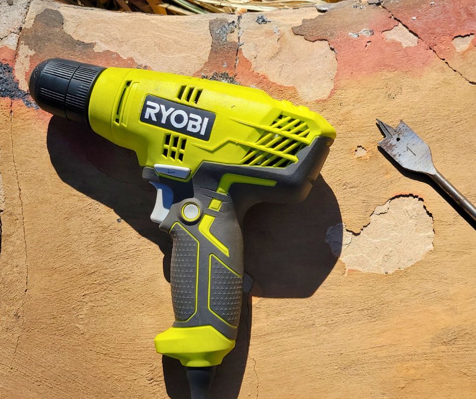 A Robi electric hand drill and a #1 bit for drilling holes in planters.