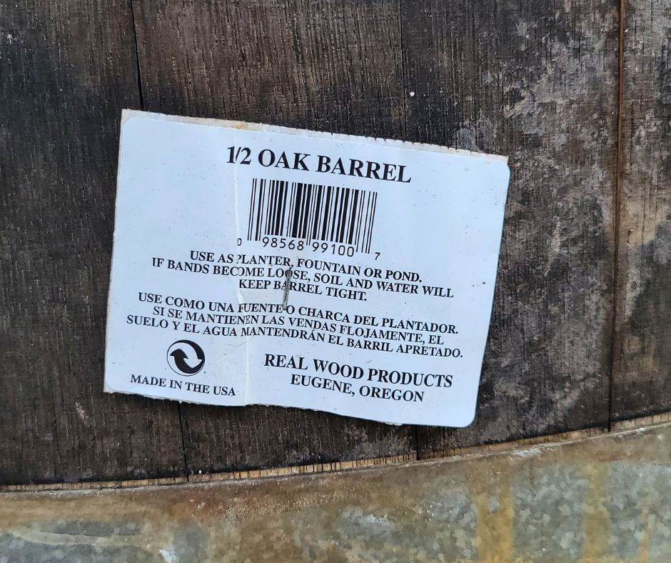 Tag on wooden half barrel declaring that is from the USA and size.