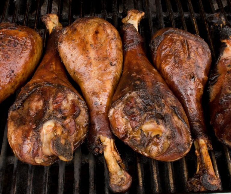Smoked turkey legs staying warm in a backyard smoker.