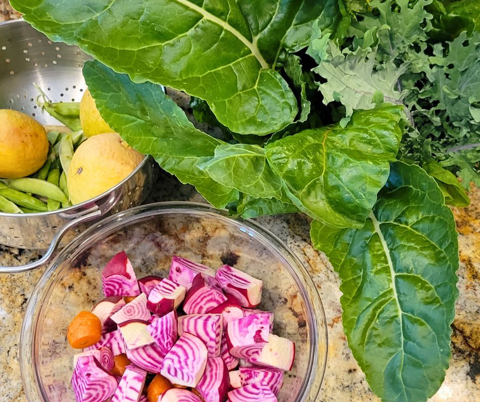 Cut beets, chard, and kale on a counter top.
