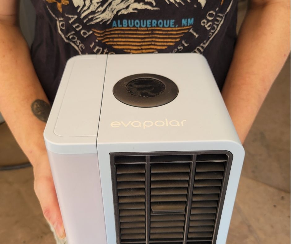 A man holding a portable AC unit.