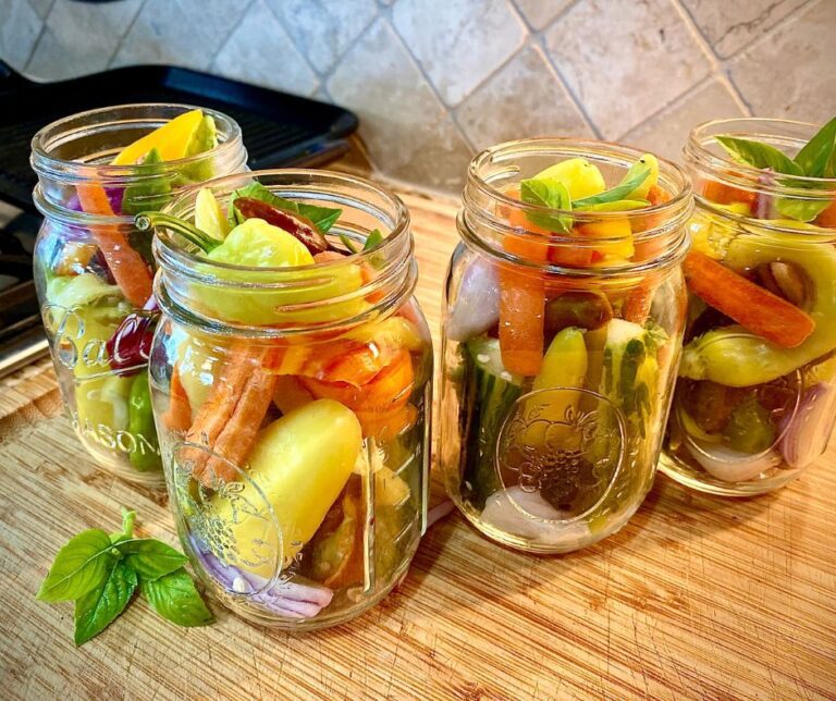 Glass jars of garden vegetable melody prepped for canning.