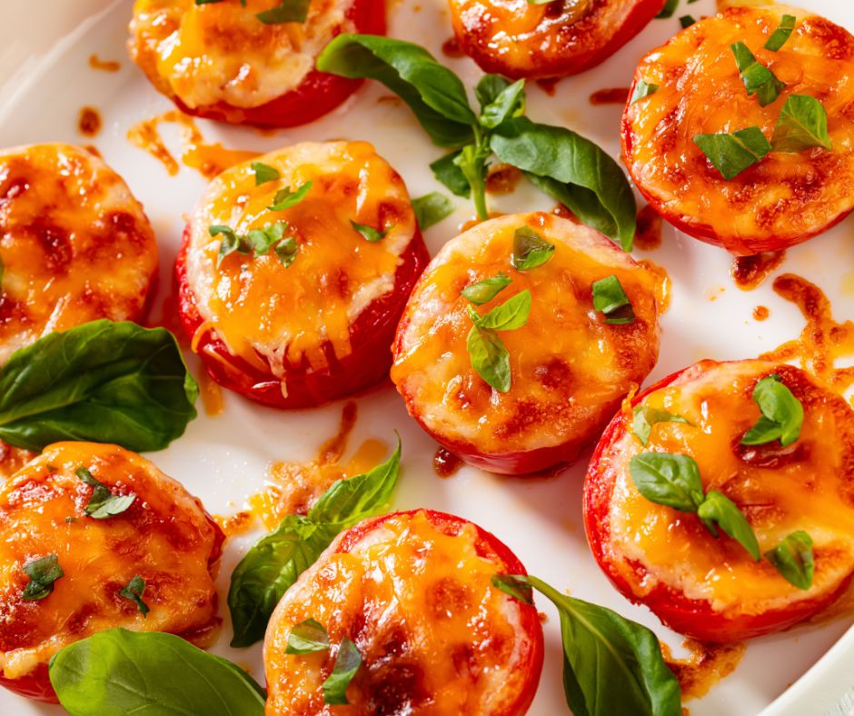 Cheese and basil topped baked tomato slices.