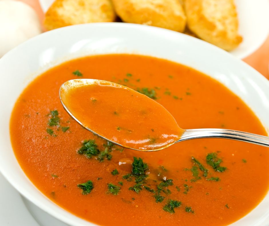 A smooth red soup in a white bowl.