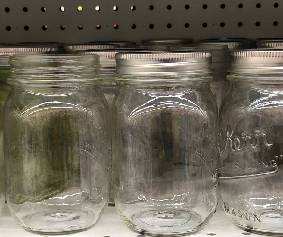 A shelf of empty mason jars.