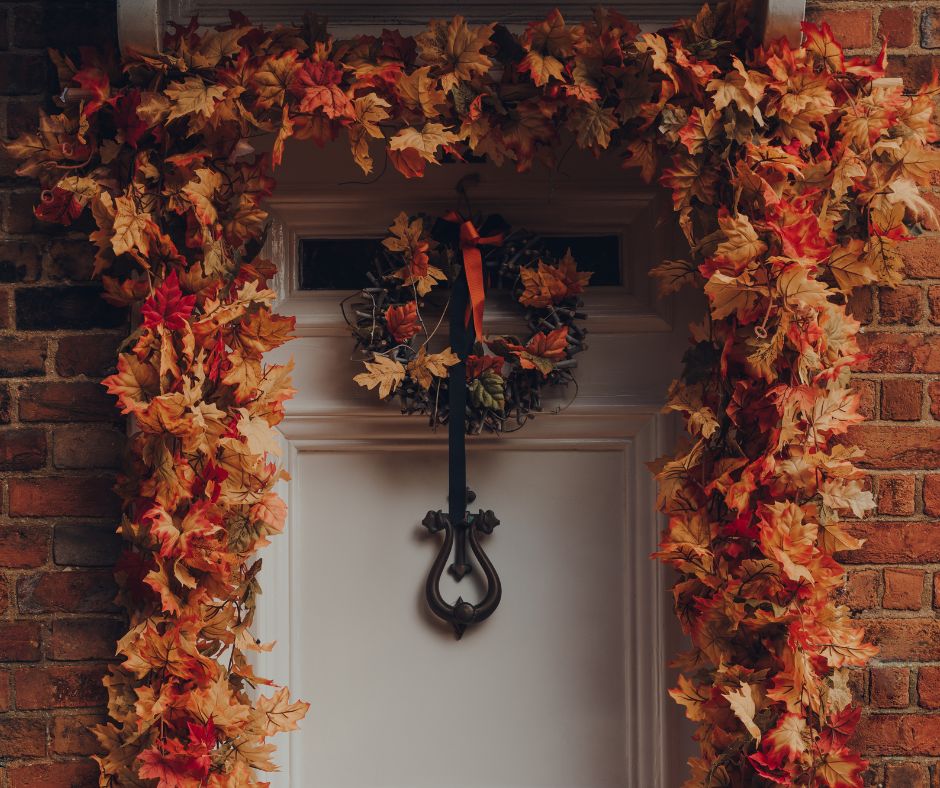 A door garland of fall leaves and a wreath.
