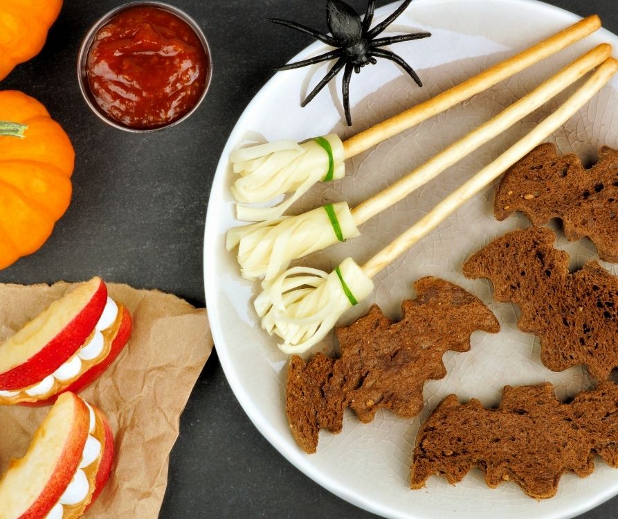 Pretzel and string cheese brooms with toast bats and apple dentures.