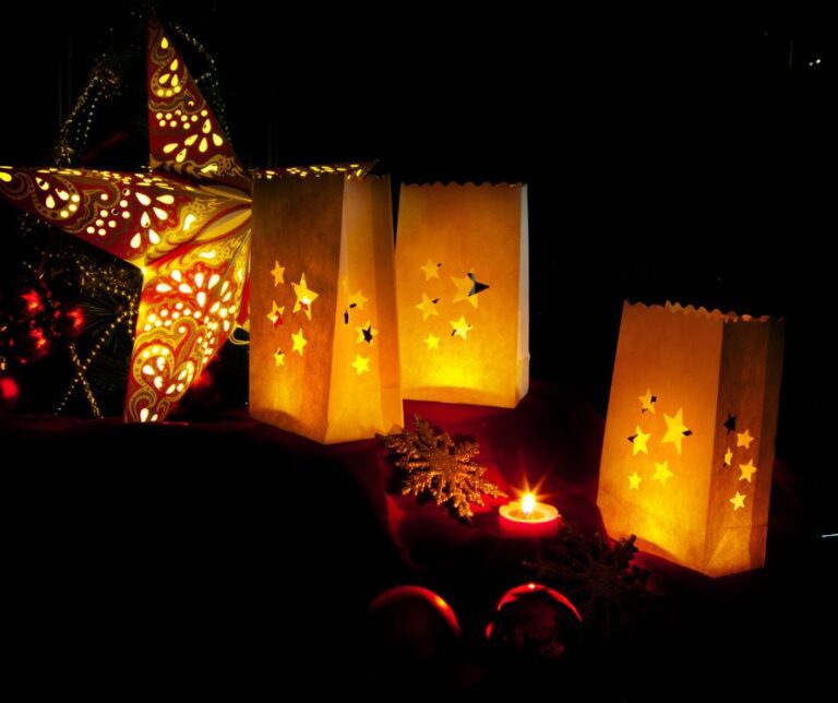 Fall decorations including a star and farolitos with shapes cut out of the paper bags to let candle light through.