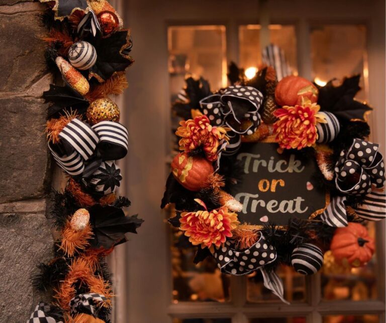 A door outlined in Halloween decorations and a wreath in black and orange. A sign reads "Trick or Treat" in whimsical font.