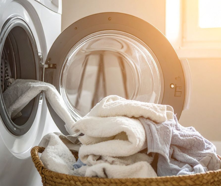 A load of laundry being removed from the dryer.