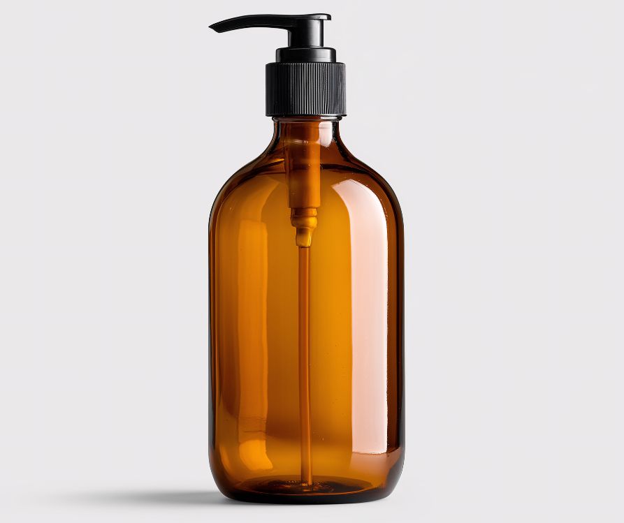 An amber pump jar with a black plastic top.