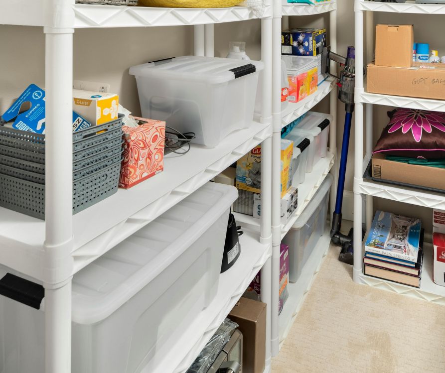 Clear totes on shelving in a garage.